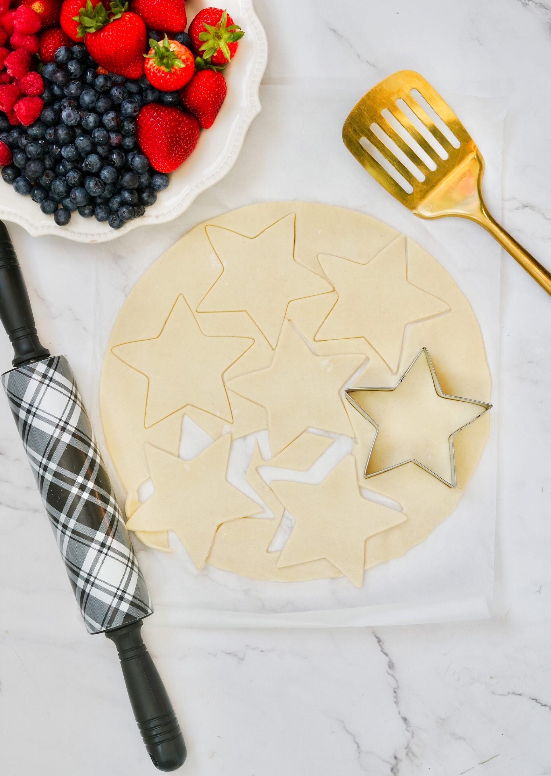 Cutting pie crust with a star shaped cutter.