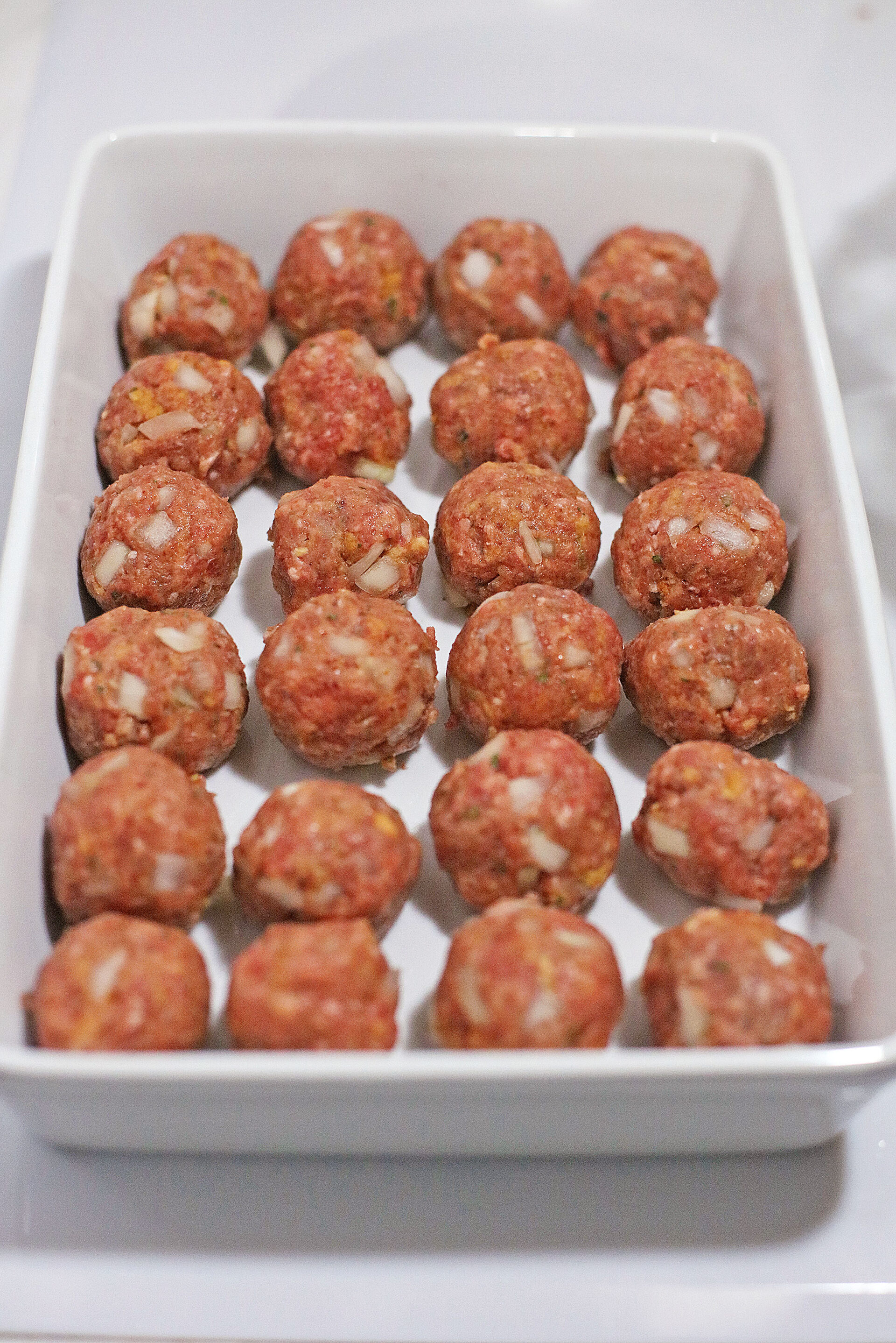 Stove top stuffing meatballs in a baking dish.