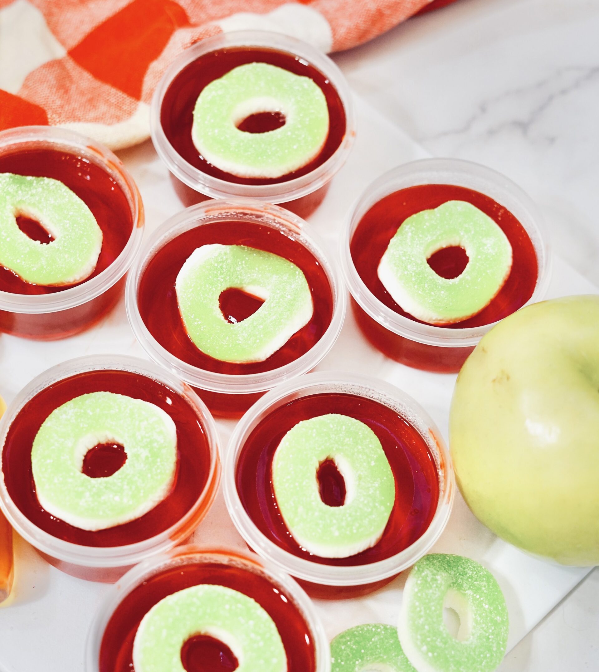 Apple pucker jello shots on a tray.