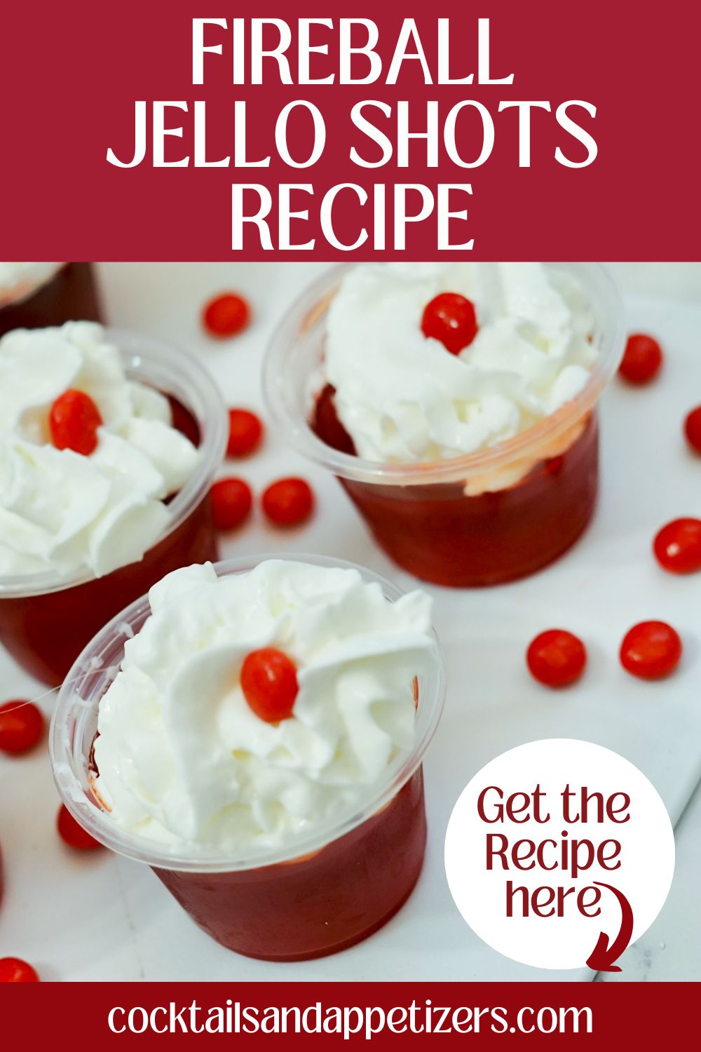 Fireball Jello Shots with whipped cream and red hot candy garnish on a tray