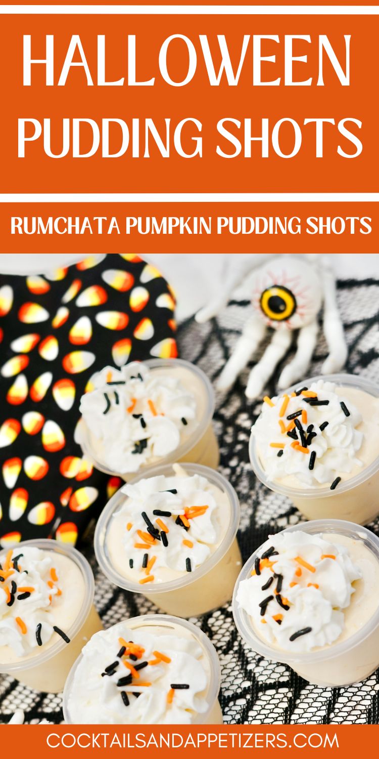 Halloween Pumpkin Rumchata pudding shots with whip cream and sprinkles. Sits on table with Halloween decorations.