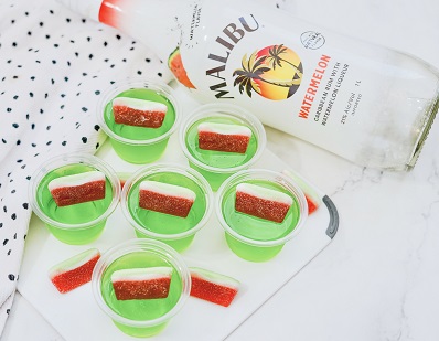 Jello shots with Malibu Rum watermelon flavor with candy garnish on a tray
