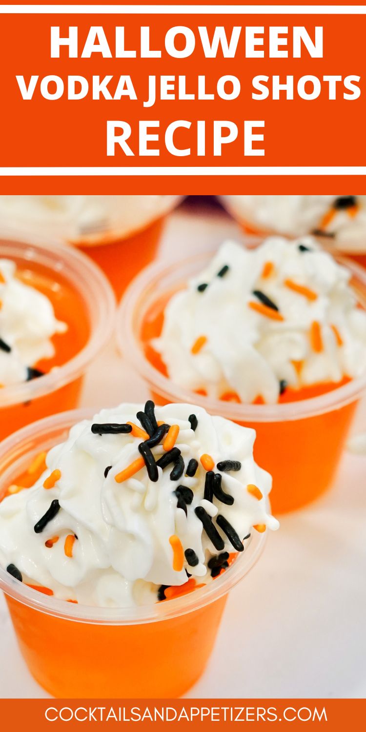 Halloween Vodka Jello shots topped with whipped cream then garnished with sprinkles. Sitting on a tray ready to serve.