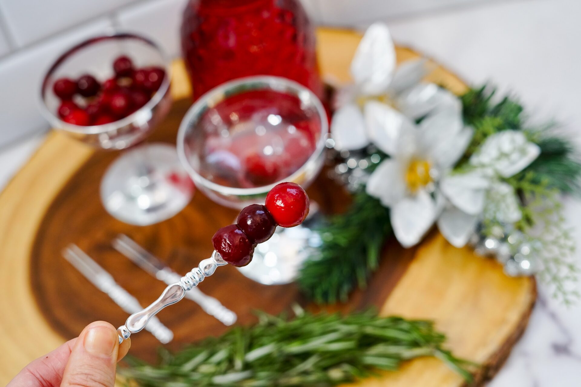 A cocktail fork with cranberries.