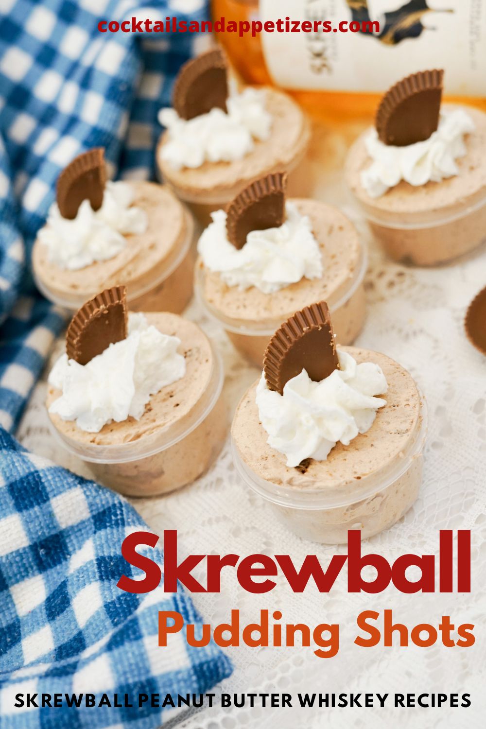 Skrewball pudding shots in small cups garnished with whipped cream and mini peanut butter cups.