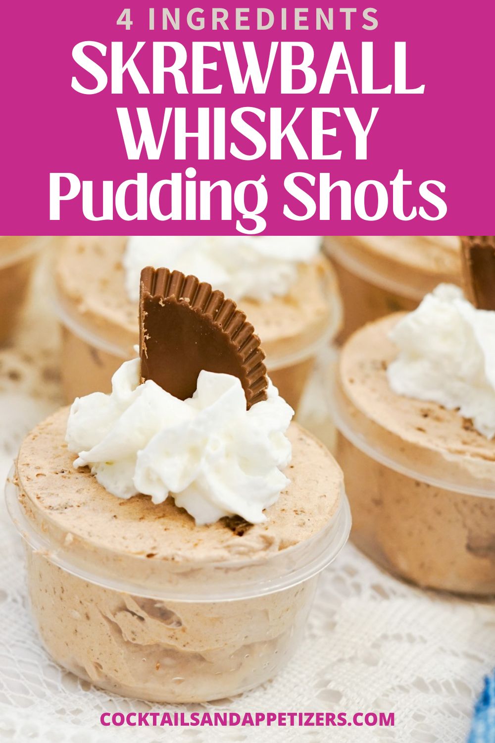 Skrewball whiskey pudding shots in cups with whipped cream and peanut butter cup garnish sit together on a table.