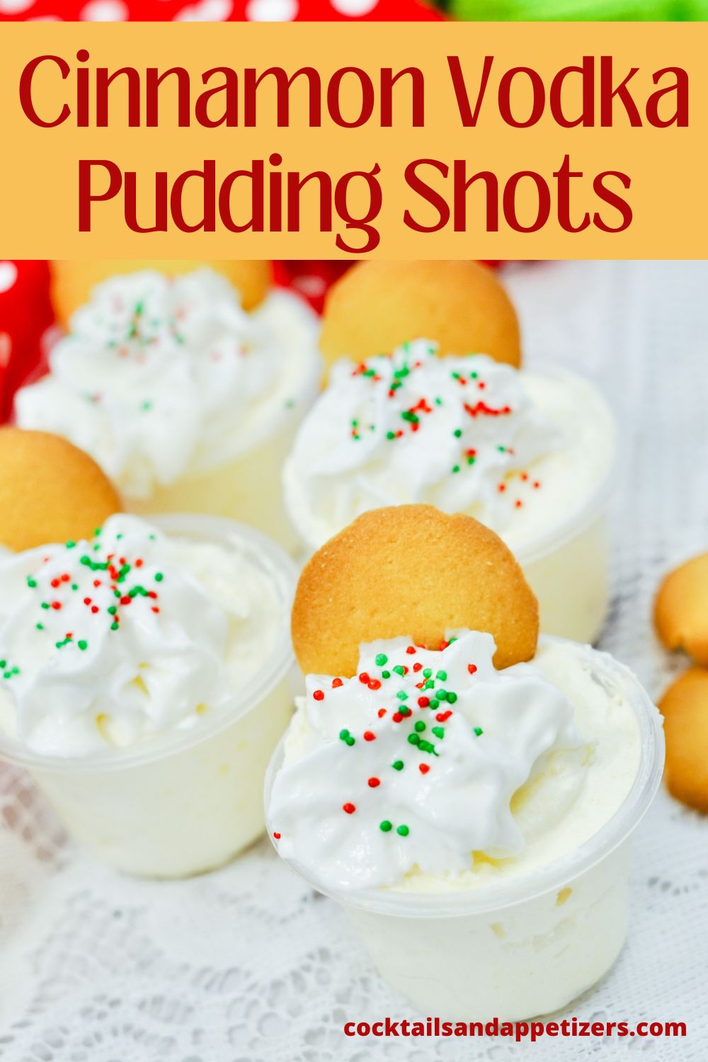 Cinnamon vodka pudding shots with a sugar cookie garnish and sprinkles on a tray.