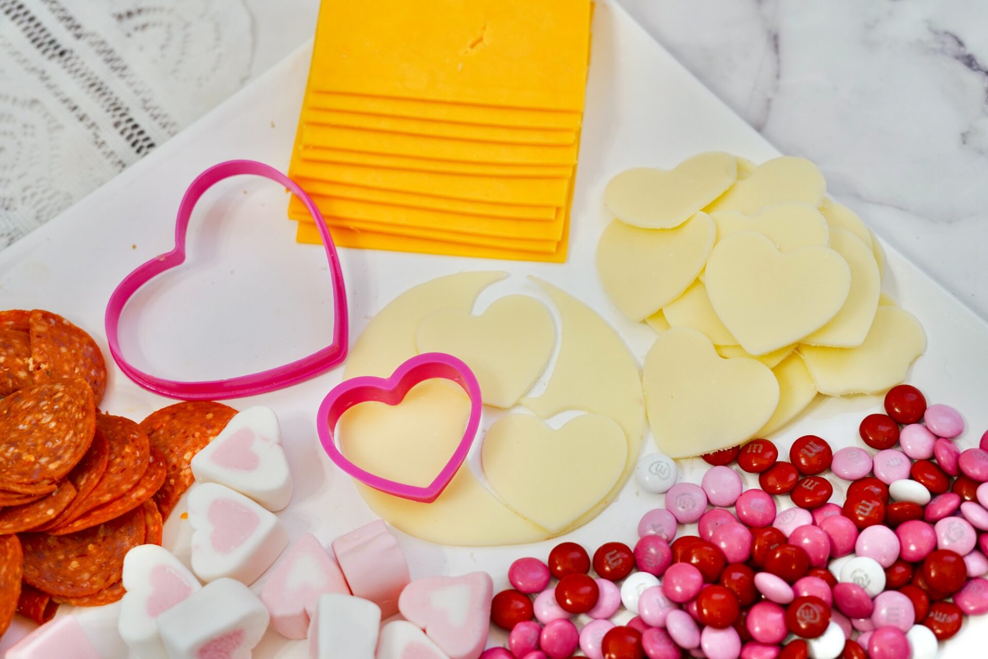 Cutting Heart Shapes out of Cheese Slices for the Valentine's Day charcuterie board