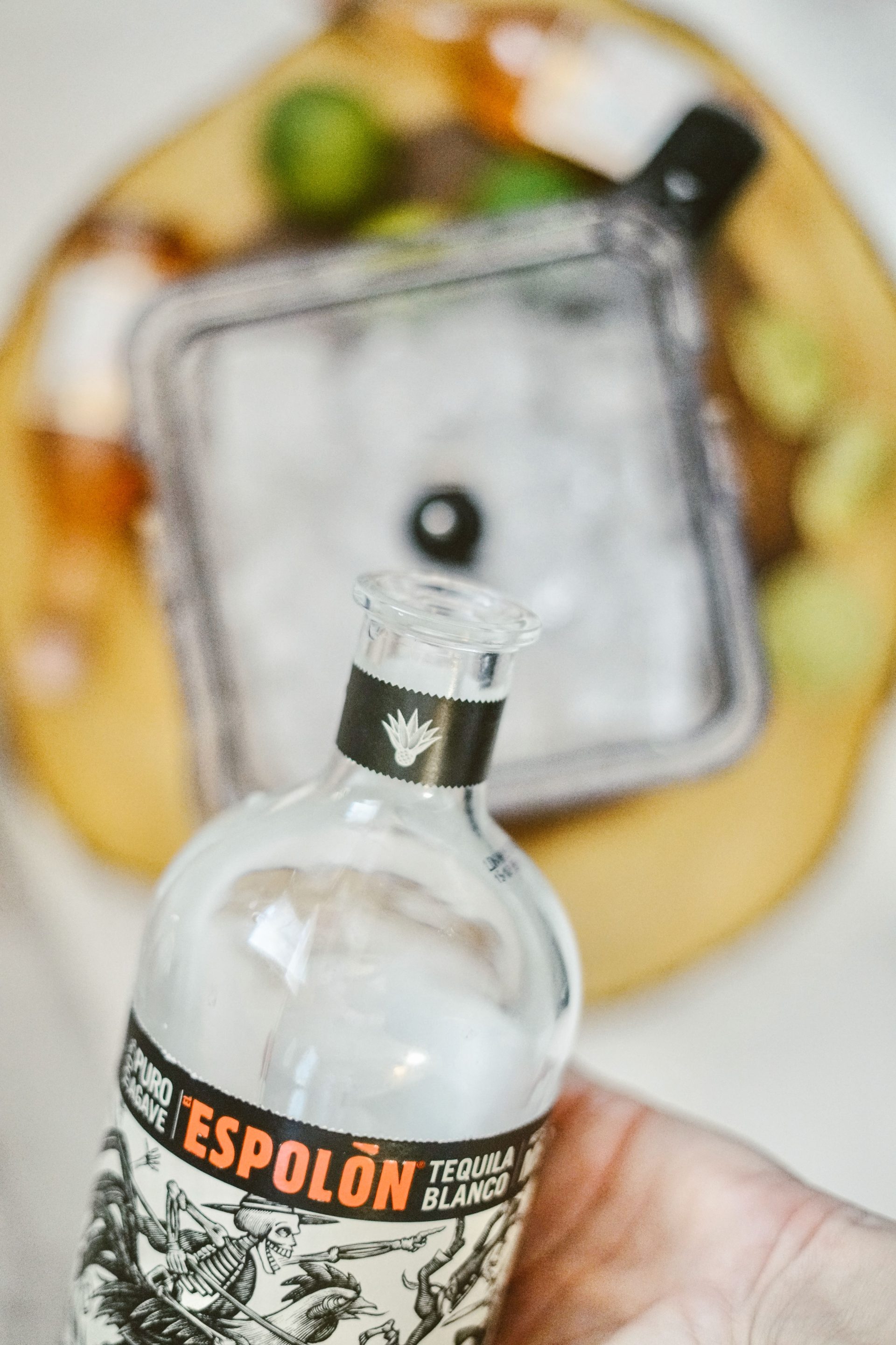 Adding tequila to a blender full of ice.