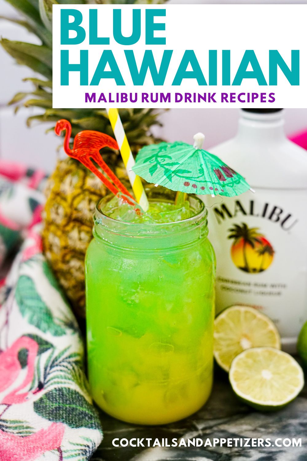 Malibu Blue Hawaiian drink on a tropically decorated table with a bottle of Malibu rum, a large whole pineapple and colorful cloths.
