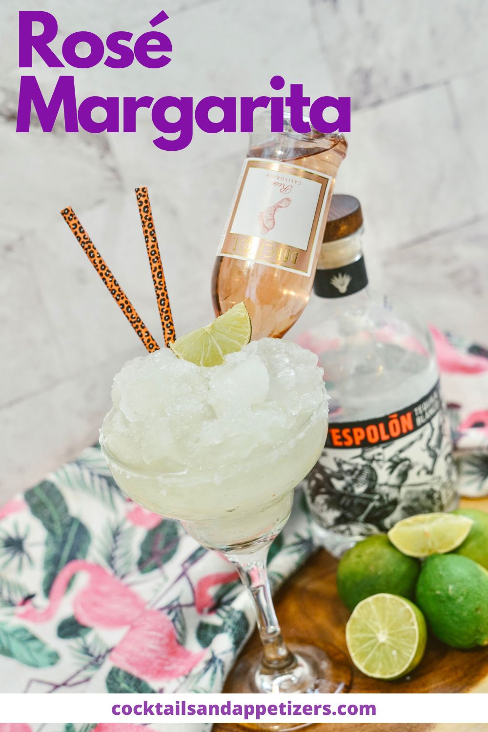 Rosé Margarita in a glass with straws and a mini Rose bottle upside down. A bottle of tequila stands behind the glass.