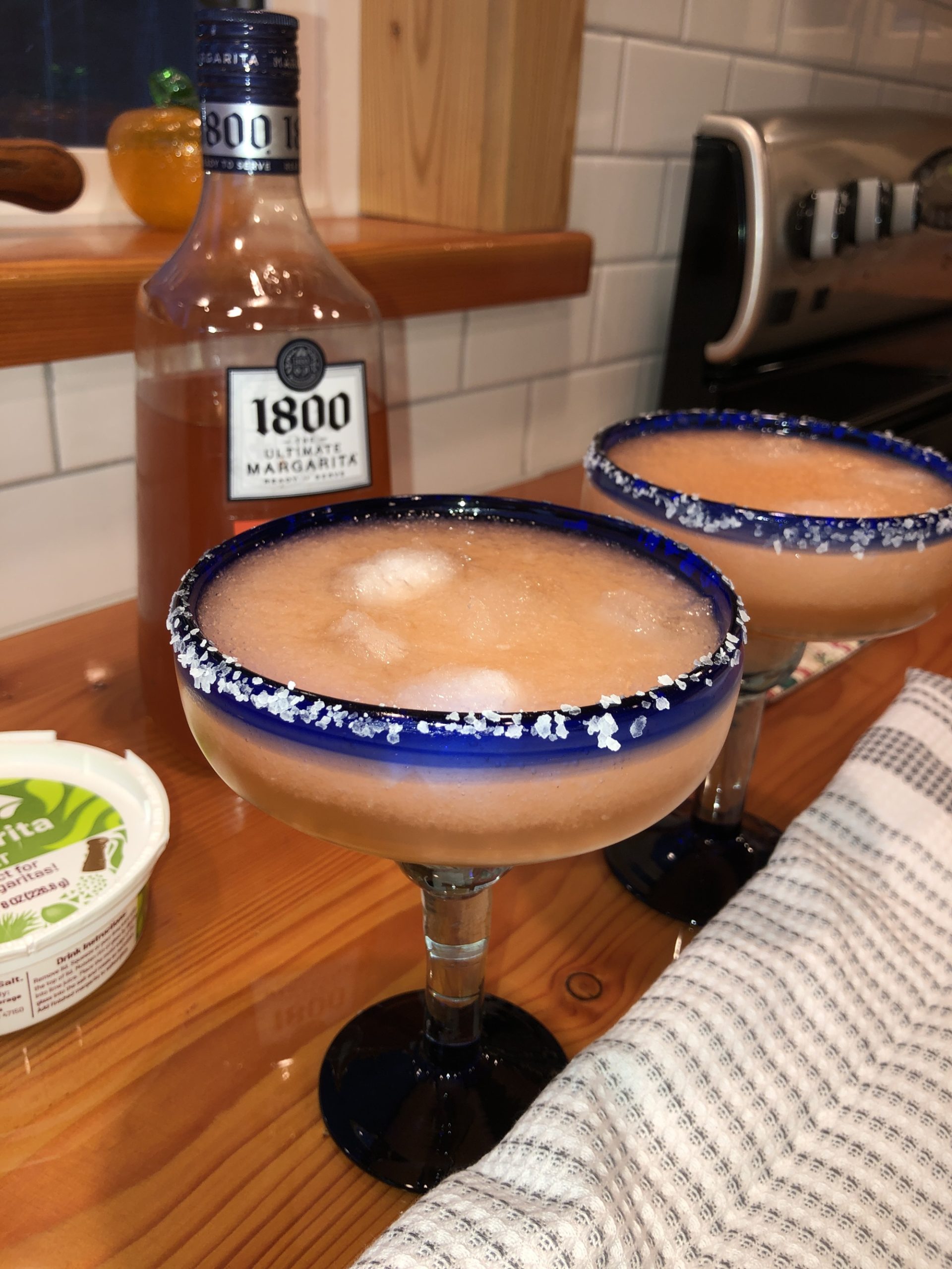 1800 Ultimate Margarita Watermelon slushie drinks in glasses on a counter.