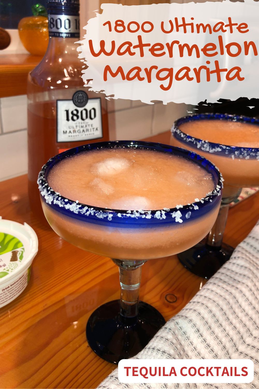 1800 Ultimate Watermelon Margarita in a blue rimmed glass.