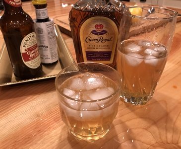 Horsefeather Cocktails on a wood table with drink ingredients behind.