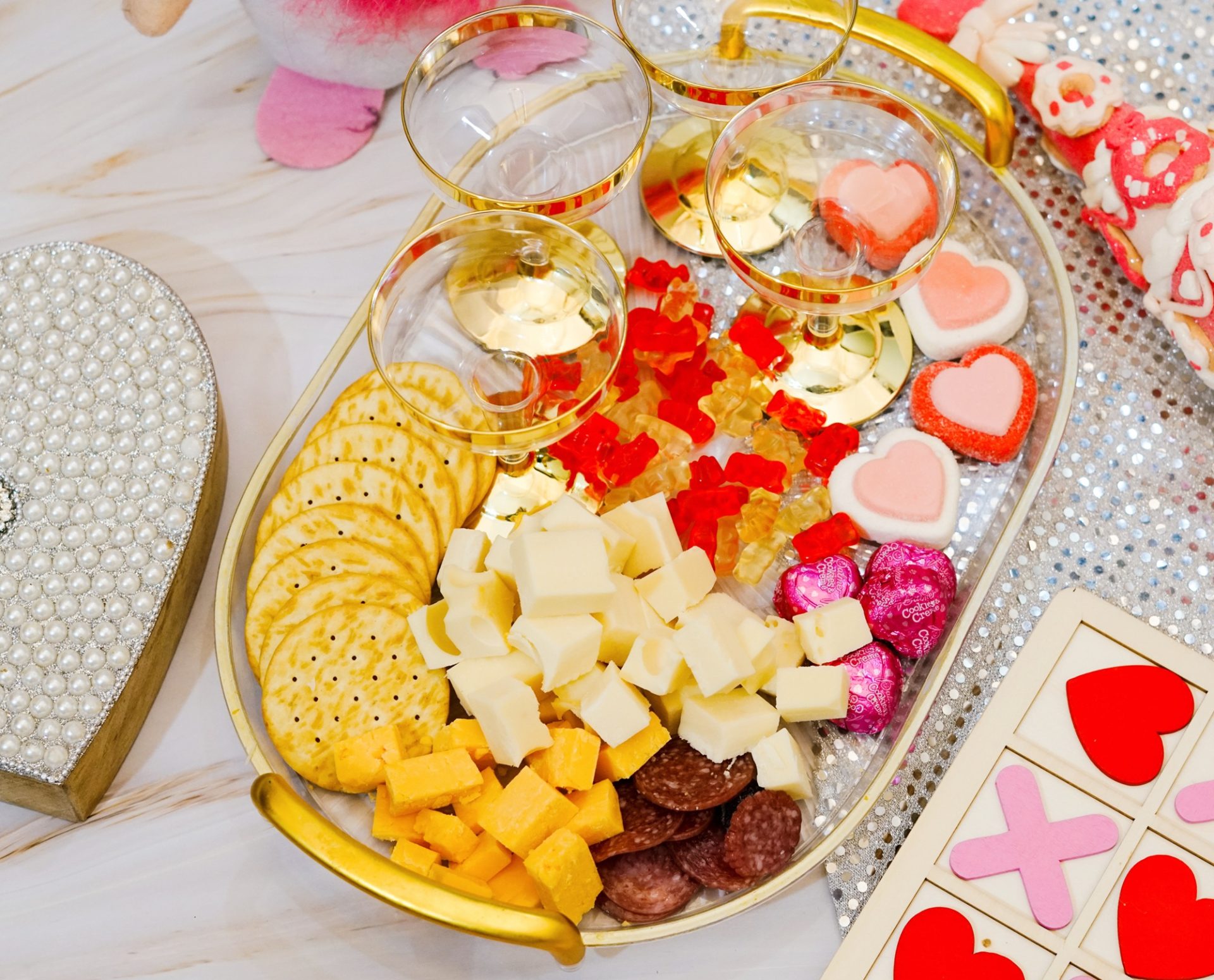 Charcuterie cups ingredients on a gold tray