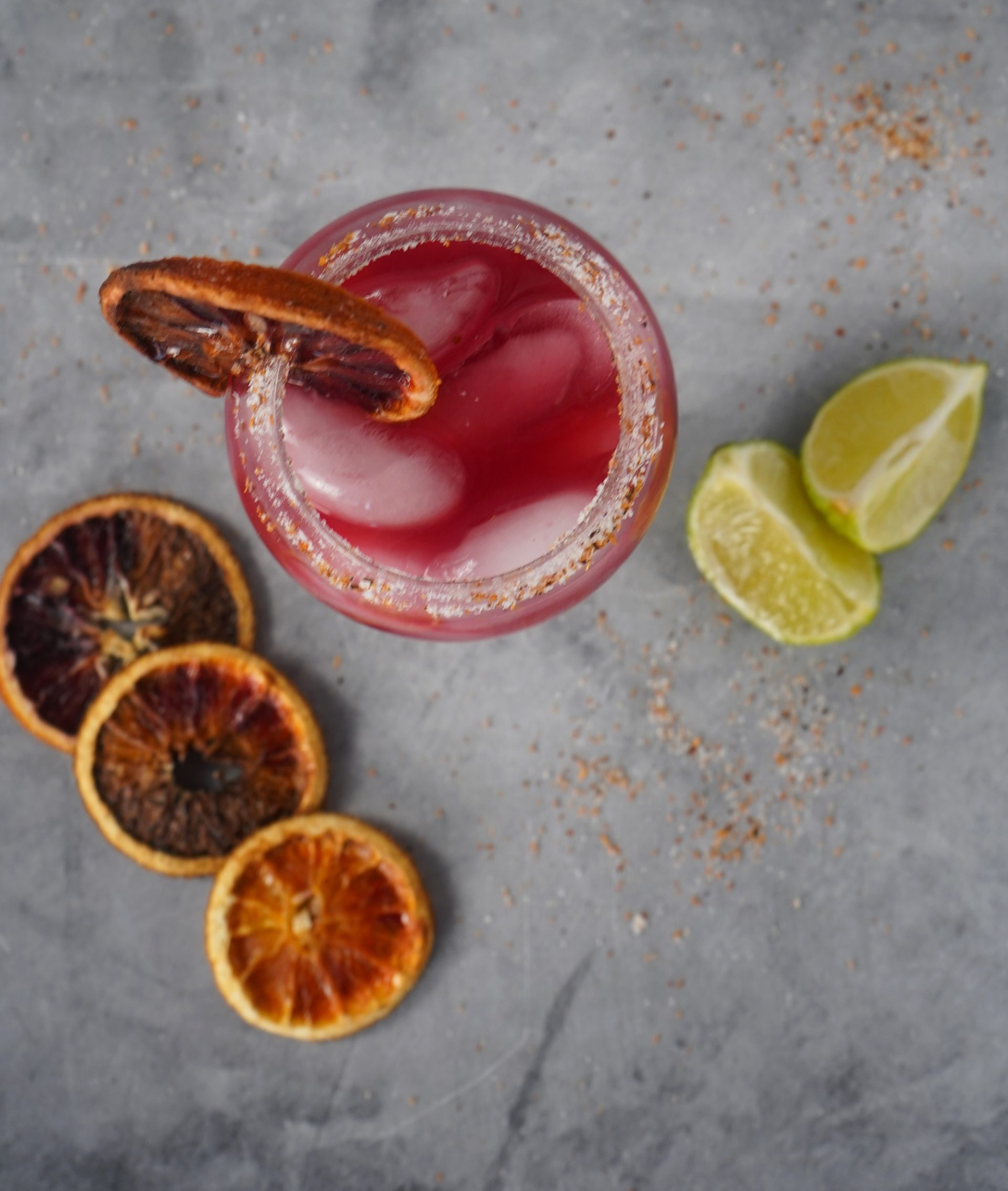 Blood orange margarita cocktail in a rimmed glass.