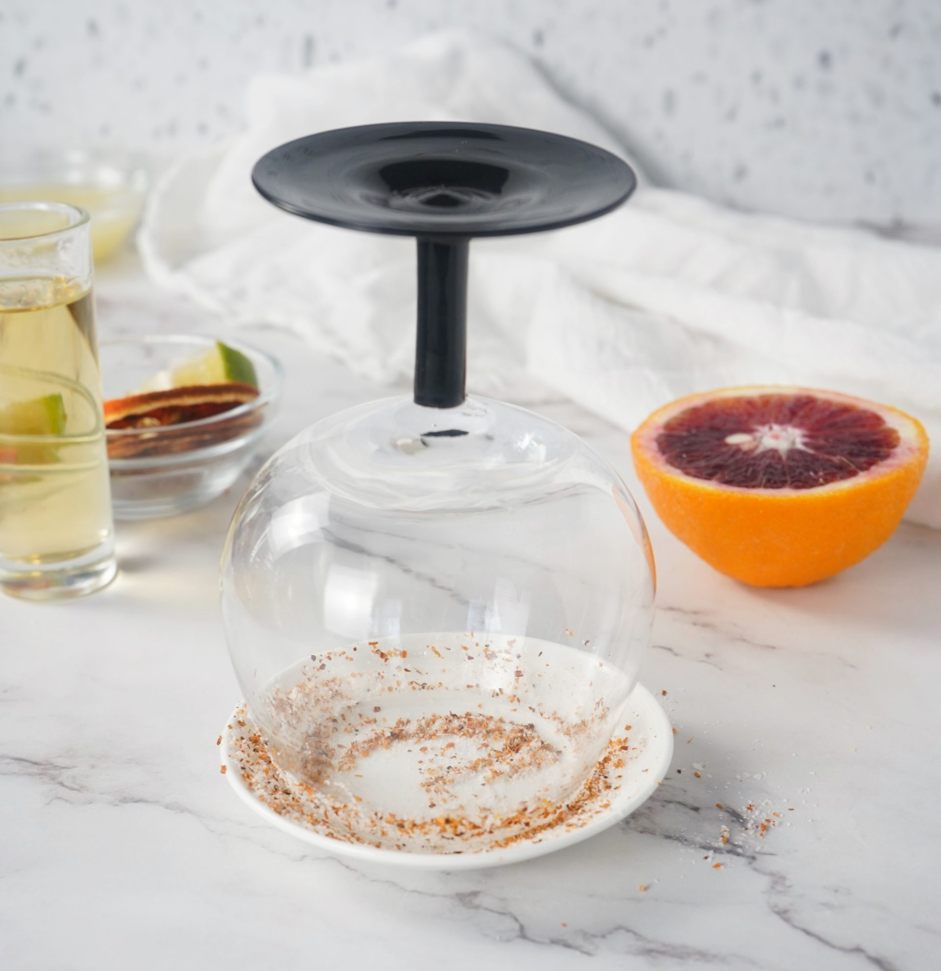 Glass being dipped in Tajin for rimming.